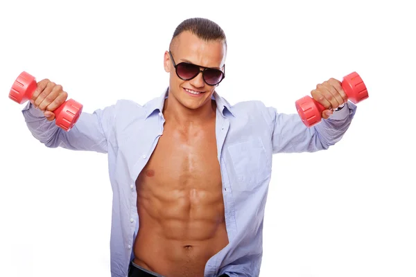 Portrait of handsome man posing in studio with dumbbels — Stock Photo, Image