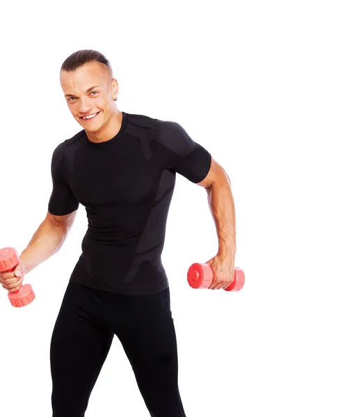 Portrait of strong man posing in studio with dumbbells — Stock Photo, Image