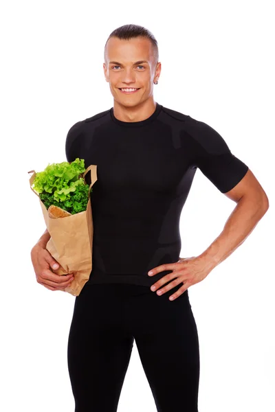 Portrait of sexy man posing in studio with vegetables — Stock Photo, Image