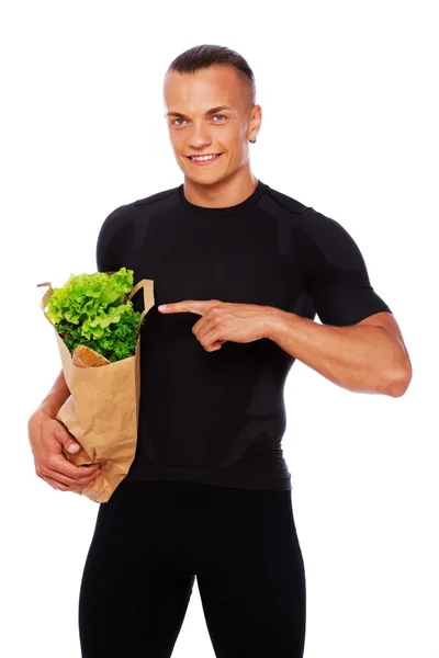 Portret van sexy man poseren in studio met groenten — Stockfoto