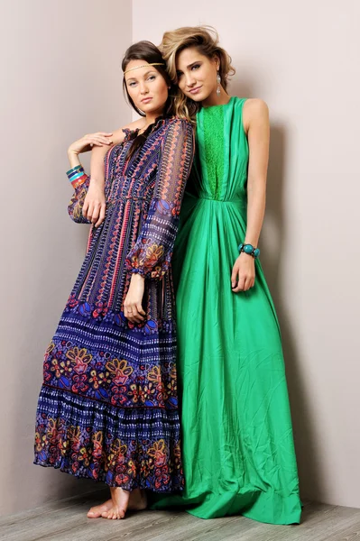 Two beautiful woman posing in a fancy dresses — Stock Photo, Image