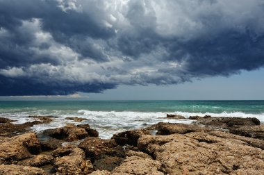 Sea landscape with rocky coast and storm sky . clipart