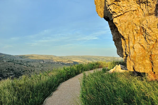 stock image Sunset landscape with big overhung rock and mountain view. Ares