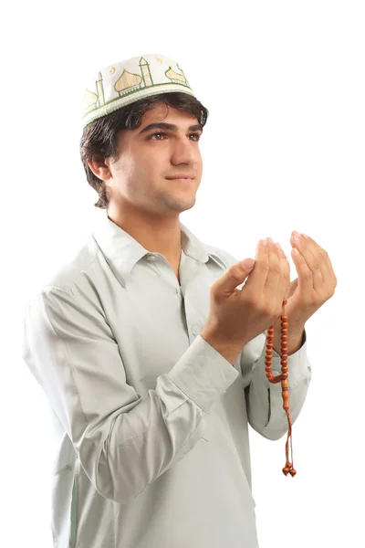 Νέος άνθρωπος που κρατά ένα κομπολόι σε στάση προσευχή και ζητώντας — Φωτογραφία Αρχείου