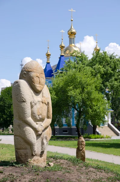 stock image Polovtsian stone sculpture in the background of the Orthodox Chu