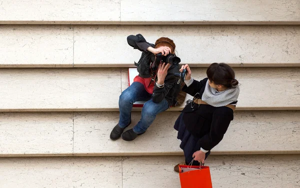 Girls photographers on staircase — Stock Photo, Image
