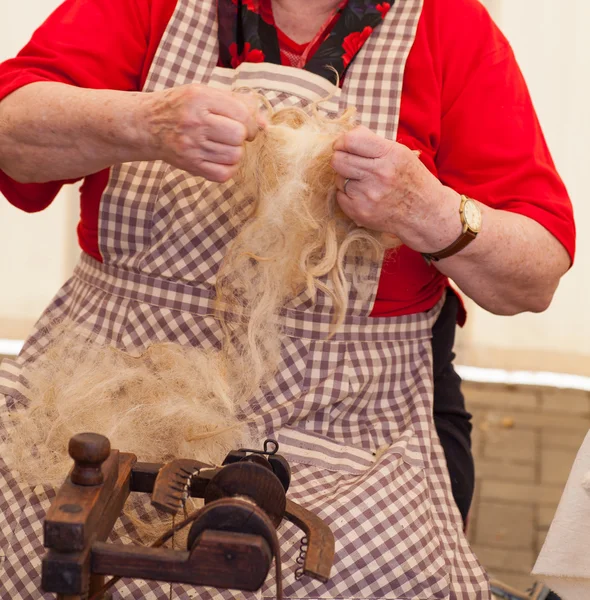 Elderly woman spinning wool — Zdjęcie stockowe