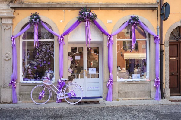 Stock image Purple bike next to a lavender shop