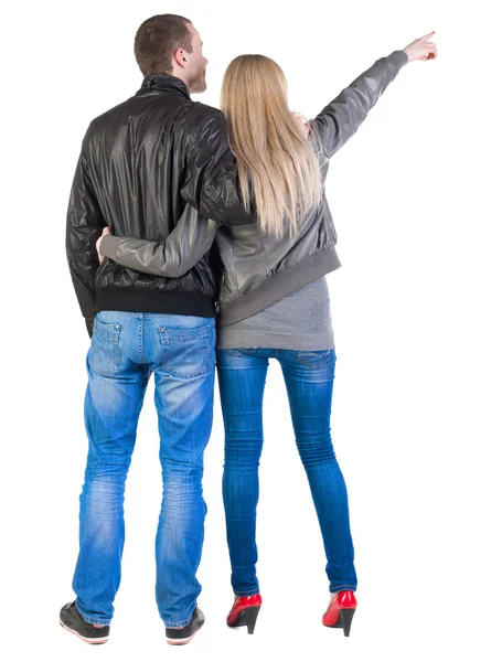 Young couple pointing at wal Back view (woman and man). — Stock Photo, Image