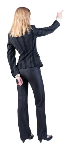Vista de mulher de negócios loira jovem apontando wal traseira — Fotografia de Stock