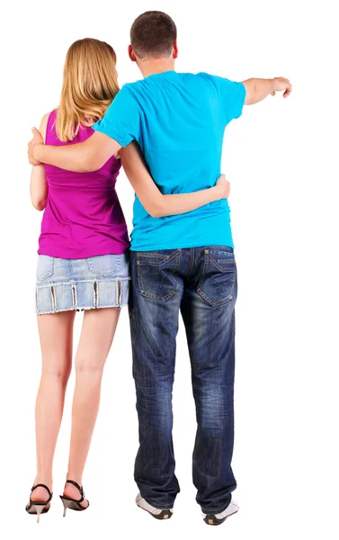 Back view of young couple pointing at wall — Stock Photo, Image