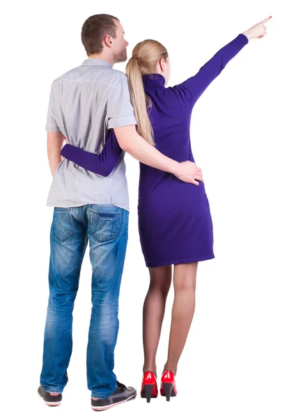 Young couple pointing at wal Back view — Stock Photo, Image