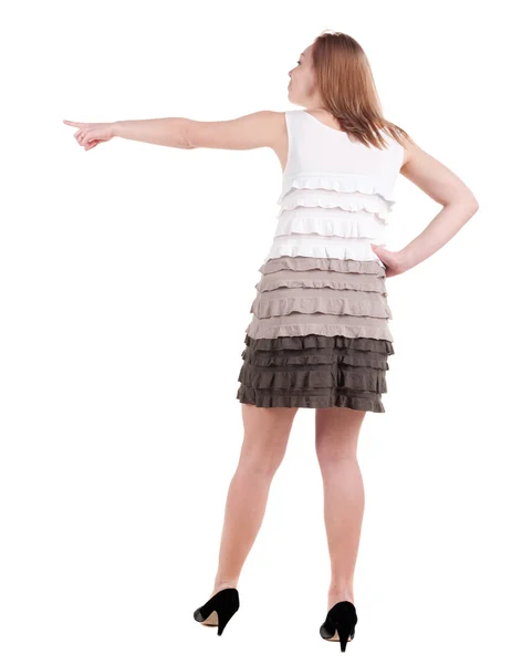 Back view of young blonde woman pointing — Stock Photo, Image