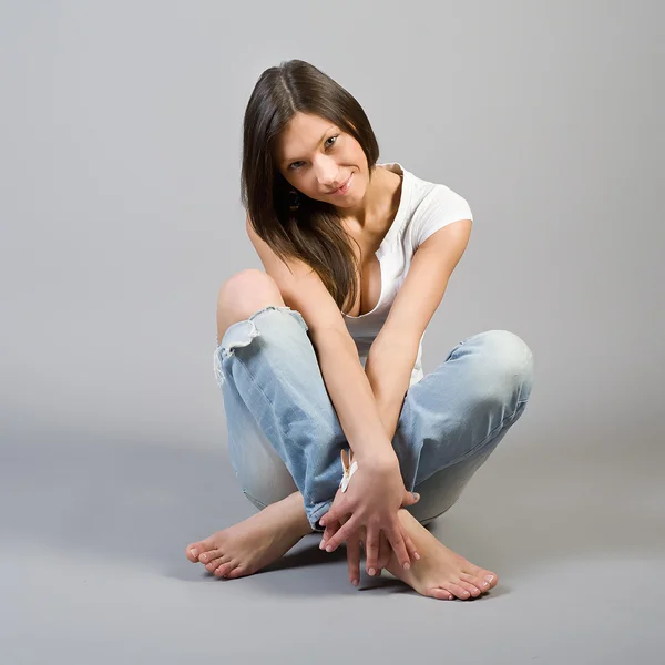 Girl in torn jeans — Stock Photo, Image