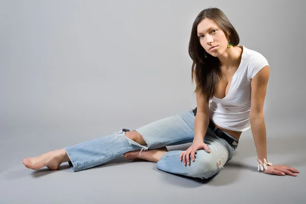 Meisje in gescheurde spijkerbroek — Stockfoto
