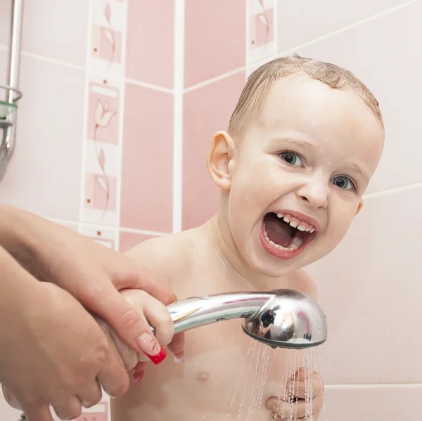 stock image A little boy takes a shower