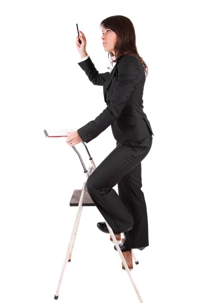 Business woman climbing ladder — Stock Photo, Image