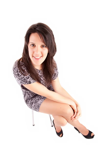 Beautiful brunette sitting on a chair — Stock Photo, Image