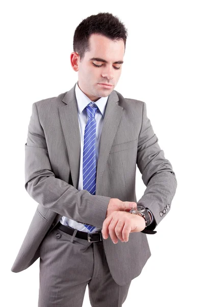 Jovem homem de negócios consultando seu relógio — Fotografia de Stock