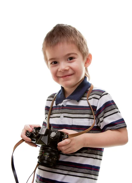 Petit garçon avec une caméra dans les mains sur un fond blanc — Photo