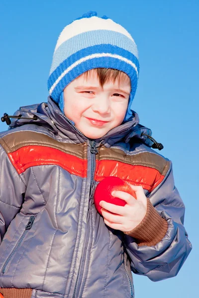Little boy with fruit in hands — Stock Photo, Image