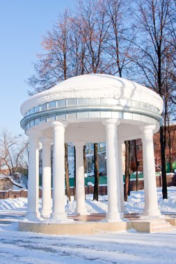 Rotunda in a winter park, city Perm clipart