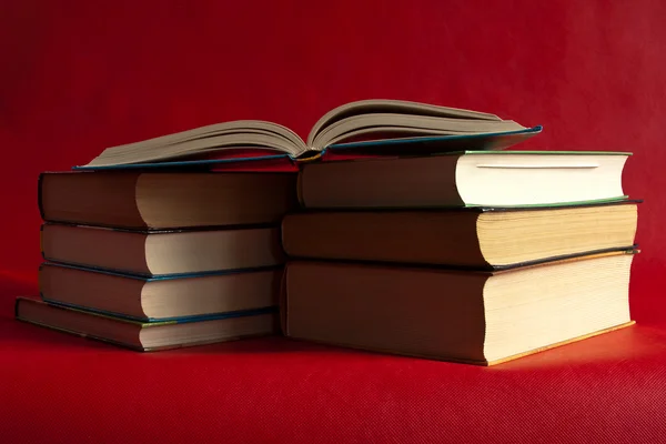 Books are on a bright red background — Stock Photo, Image