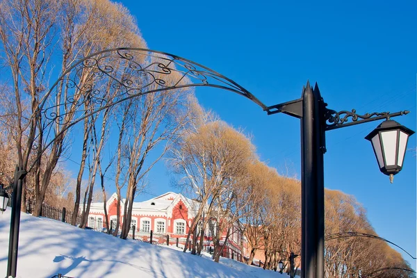 Lantern in a winter park on a background blue sky — Stock Photo, Image