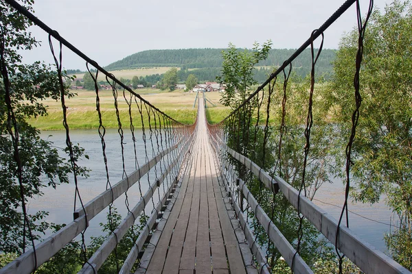 Rural landscape with the suspended bridge — Stock Photo, Image