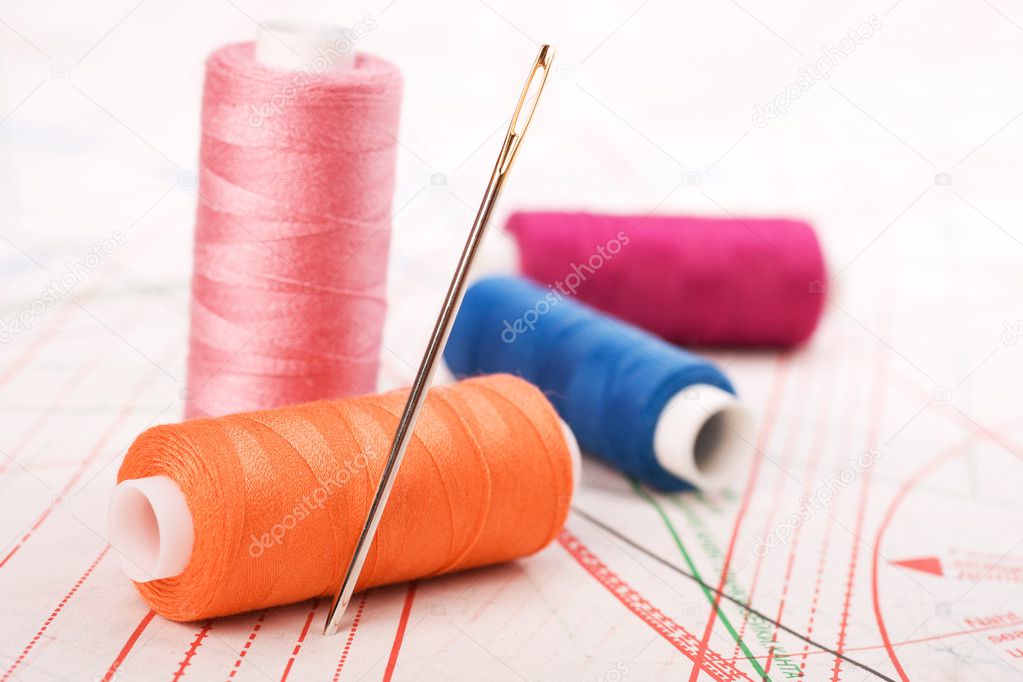Spool of thread and needle. Sew accessories.