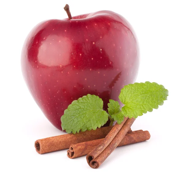 Red apple, cinnamon sticks and mint leaves still life — Stock Photo, Image