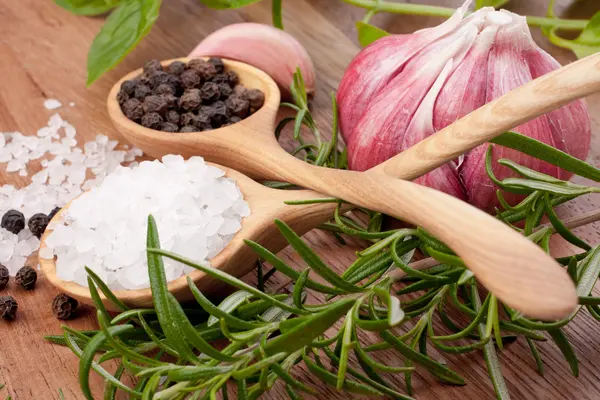 Fresh herbs and salt spoon — Stock Photo, Image