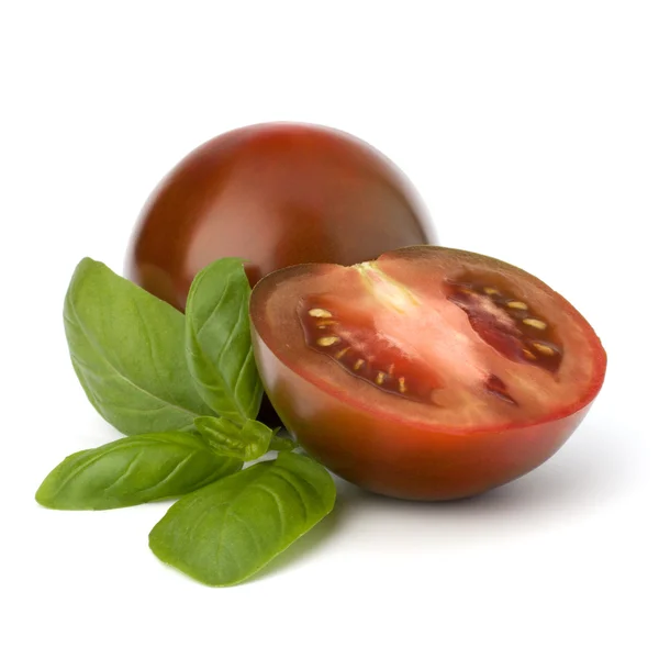 Tomato kumato and basil leaf — Stock Photo, Image
