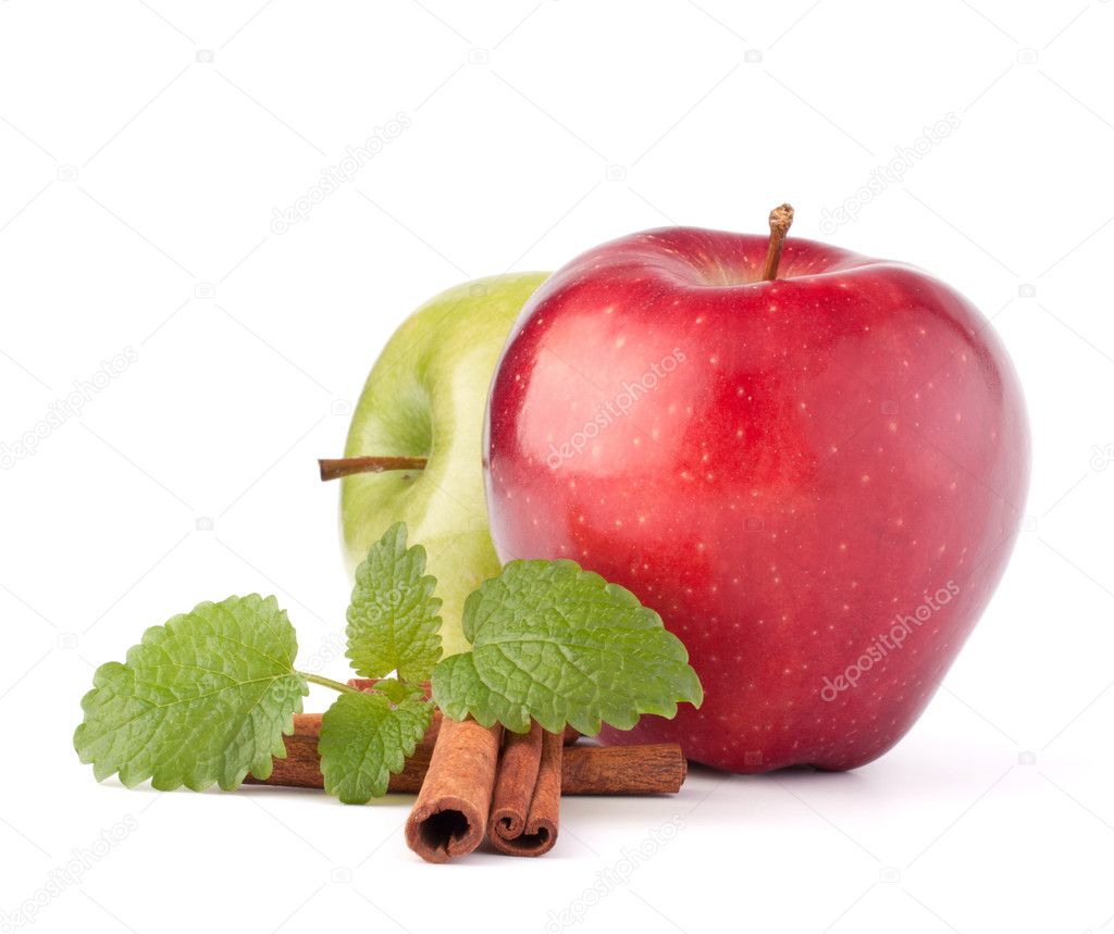 Red and green apples, cinnamon sticks and mint leaves still life