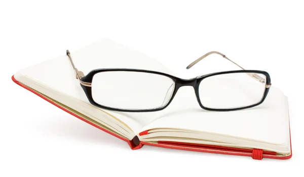 Open notebook and glasses isolated on white Stock Image