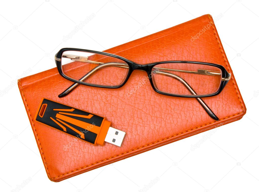 Notebook, glasses and pendrive isolated on white
