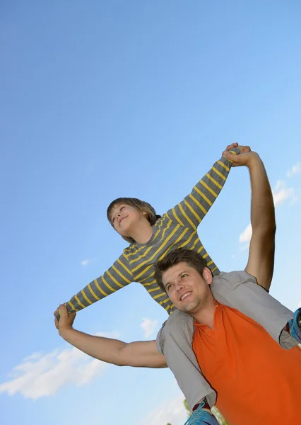 Happy son on the shoulders of the father — Stock Photo, Image