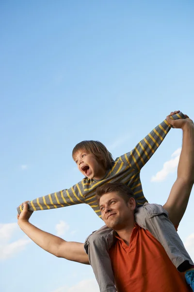 Happy son on the shoulders of the father — Stock Photo, Image