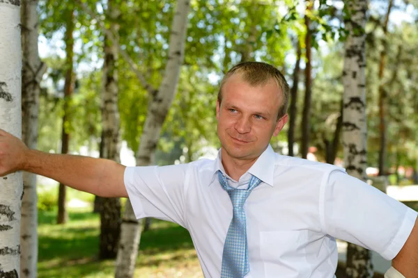 Een jonge zakenman in een wit overhemd met een stropdas — Stockfoto