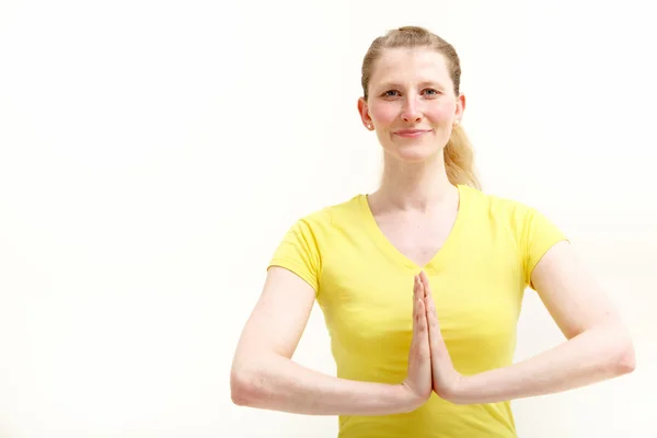 Pretty young woman with hands folded yoga fashion — Stock Photo, Image