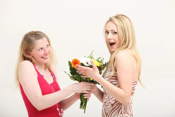 Woman exclaiming over a gift of flowers — Stock Photo, Image