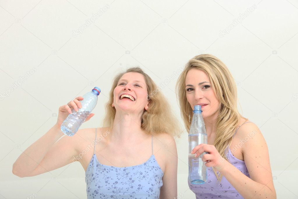 Pretty girls share a moment while getting a drink