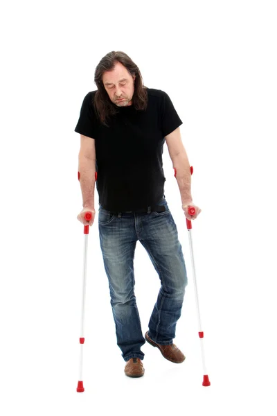 Disabled man walking on crutches — Stock Photo, Image