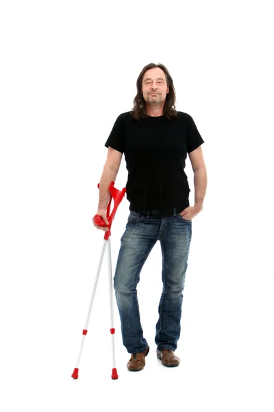 Injured middle-aged man with crutches — Stock Photo, Image