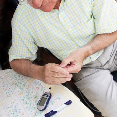 Elderly man taking a blood sample clipart