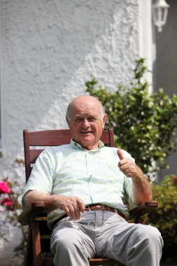 Retired man giving a thumbs up clipart