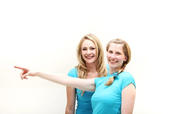 Happy women pointing off frame — Stock Photo, Image