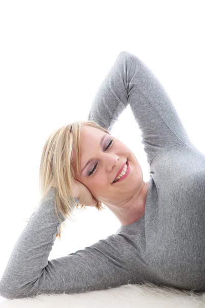 Happy woman lying on white background — Stock Photo, Image