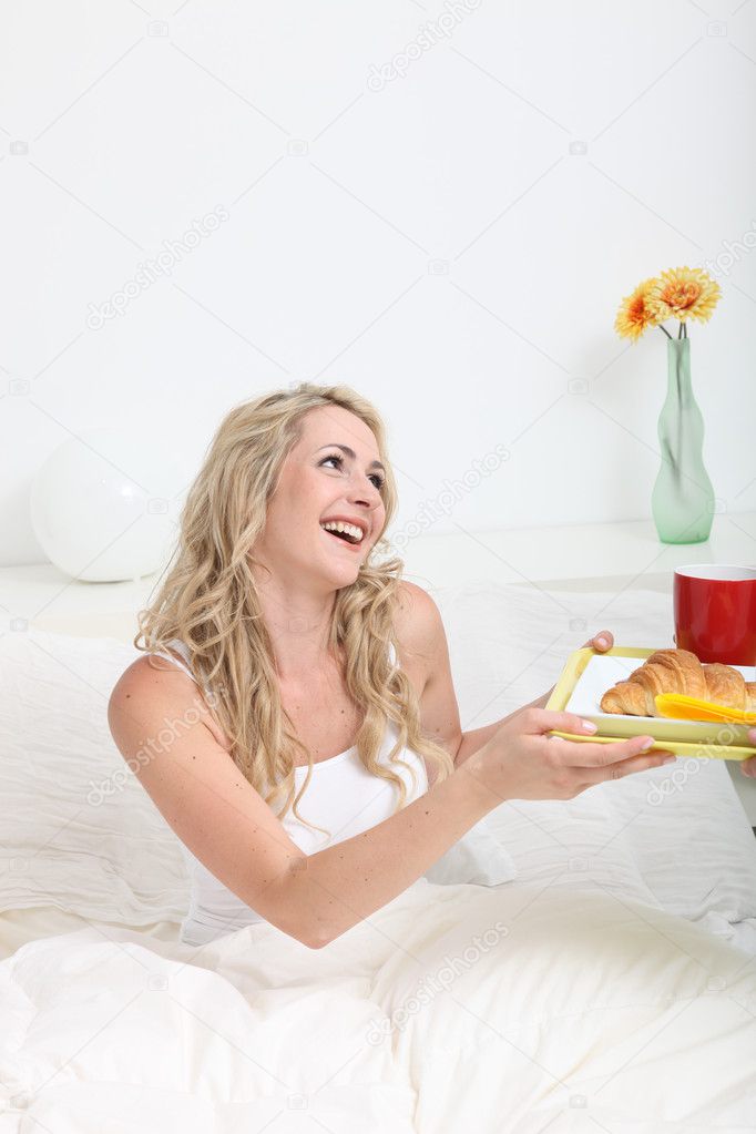 Woman receiving breakfast in bed