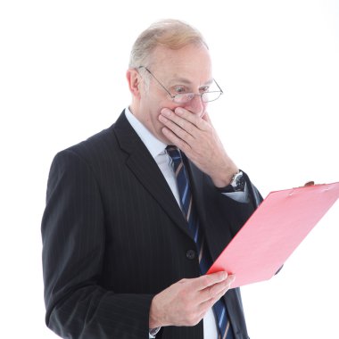 Appalled businessman reading report clipart
